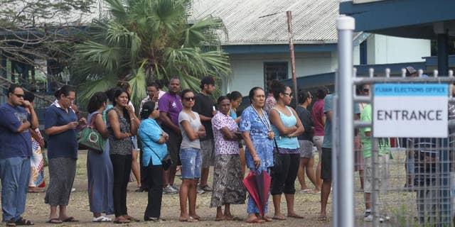 In this photo released by China's Xinhua News Agency, Fijian voters line up at a polling station in Suva, Fiji Wednesday, Sept. 17, 2014. Thousands of Fijians got their first chance to vote in eight years Wednesday in an election that promises to finally restore democracy to the South Pacific nation. (AP Photo/Xinhua, Michael Yang) NO SALES