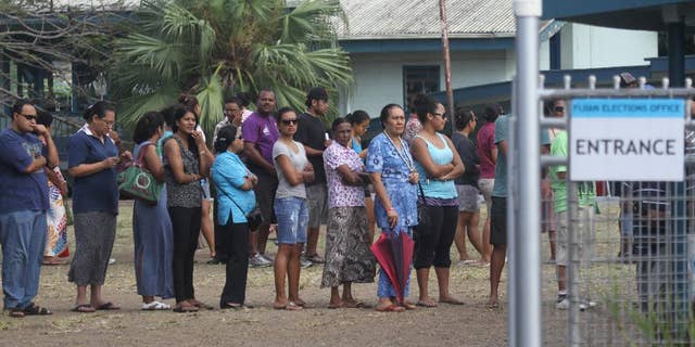 In this photo released by China's Xinhua News Agency, Fijian voters line up at a polling station in Suva, Fiji Wednesday, Sept. 17, 2014. Thousands of Fijians got their first chance to vote in eight years Wednesday in an election that promises to finally restore democracy to the South Pacific nation. (AP Photo/Xinhua, Michael Yang) NO SALES