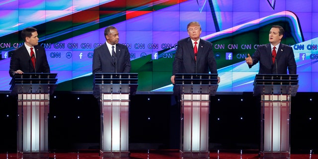 Ted Cruz, right, speaks during an exchange with Marco Rubio, left, as Ben Carson, second from left, and Donald Trump look on during the CNN Republican presidential debate at the Venetian Hotel &amp; Casino on Tuesday, Dec. 15, 2015, in Las Vegas. (AP Photo/John Locher)