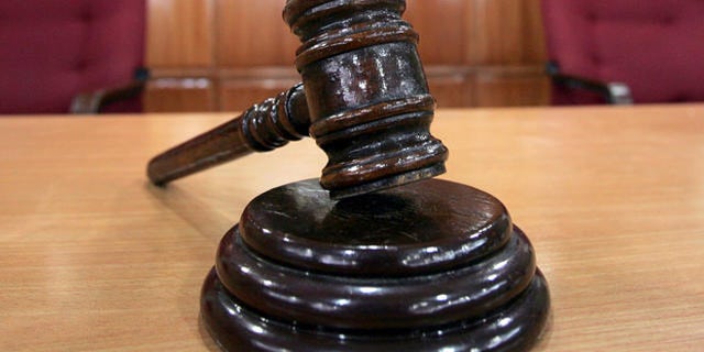 A Sandiganbayan anti-graft court sheriff adjusts chairs inside a courtroom in Quezon city northeast of Manila, Philippines, Tuesday Sept. 11, 2007, where a verdict in ousted Philippine President Joseph Estrada's corruption trial will be announced on Wednesday. (AP Photo/Bullit Marquez)