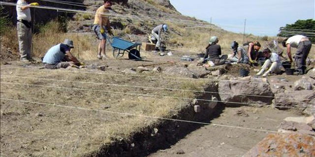 Argentine anthropologists search a lakeside beach, where they found human skeletal remains some 8,270 years old.