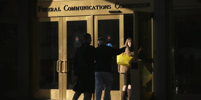 WASHINGTON, DC - DECEMBER 11: People enter the Federal Communications Commission building December 11, 2014 in Washington, DC. The commission held its monthly meeting as activists held a rally outside to call for net neutrality. (Photo by Alex Wong/Getty Images)