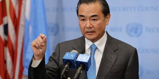 China's Foreign Minister Wang Yi speaks to the media after the UN Security Council voted to approve a resolution that will require Syria to give up its chemical weapons, on September 27, 2013 at the UN headquarters in New York