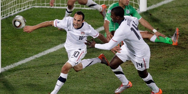 United States' Landon Donovan, front left, celebrates after scoring a goal with fellow team members United States' Clint Dempsey, back left, and United States' Edson Buddle, front right, during the World Cup group C soccer match between the United States and Algeria at the Loftus Versfeld Stadium in Pretoria, South Africa, Wednesday, June 23, 2010. (AP Photo/Michael Sohn)