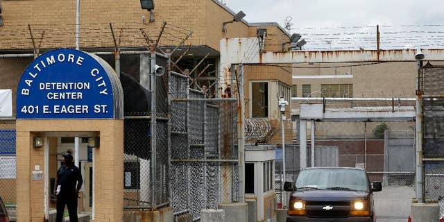 FILE - In this June 6, 2013 file photo, an inmate transport van departs from the Baltimore City Detention Center in Baltimore. Federal prosecutors said on Thursday, Feb. 5, 2015, that a federal jury in Baltimore has convicted two of the jail's guards, two inmates and a kitchen worker for their roles in a massive jailhouse drug and cellphone smuggling scheme. The defendants were part of a sweeping 44-person indictment handed down in 2013. (AP Photo/Patrick Semansky, FIle)
