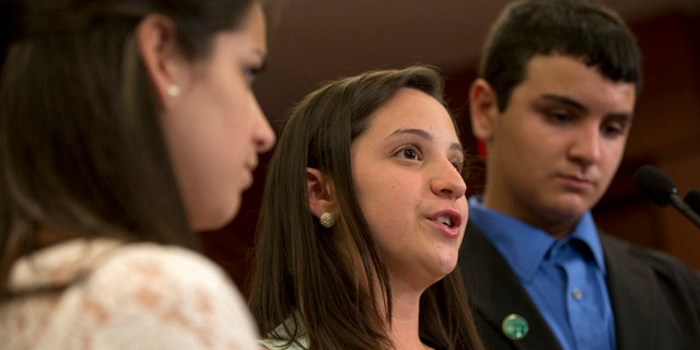 FILE - In a Thursday, June 13, 2013 file photo, Jillian Soto, center, with sister Carlee Soto, left and brother Carlos Soto, the siblings of Victoria Soto, speaks during a news conference on Capitol Hill in Washington, on the sixth month anniversary of the Newtown, Conn. shootings. The family of Victoria Soto, who was killed in the Sandy Hook school massacre, has applied to trademark her name in an attempt to stop others from misusing it on social media. (AP Photo/Jacquelyn Martin, File)