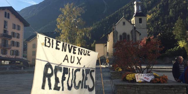 A banner set up in the main square of Chamonix, in the French Alps, reads "Welcome to Refugees" Saturday, two days before the dismantling of a refugee camp known as "The Jungle" in Calais.