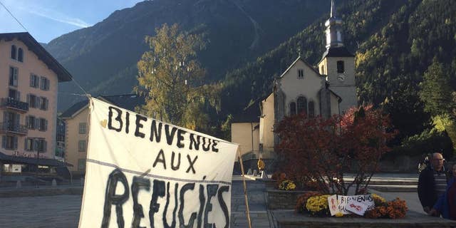 A banner set up in the main square of Chamonix, in the French Alps, reads "Welcome to Refugees" Saturday, two days before the dismantling of a refugee camp known as "The Jungle" in Calais.