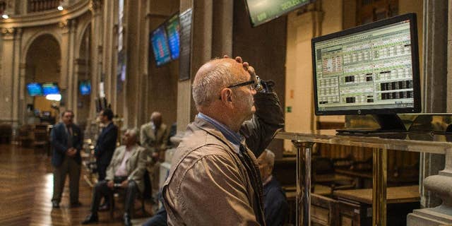 A broker gestures as he looks at a screen at the Stock Exchange in Madrid, Monday, June 29, 2015. Spain’s economy minister has said a Greek debt deal is still reachable before a deadline on the nation’s credit from the European Central Bank runs out at midnight Tuesday. Spain’s benchmark Ibex stock index slid nearly 4 percent Monday morning. (AP Photo/Andres Kudacki)