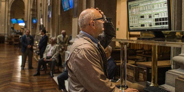 A broker gestures as he looks at a screen at the Stock Exchange in Madrid, Monday, June 29, 2015. Spain’s economy minister has said a Greek debt deal is still reachable before a deadline on the nation’s credit from the European Central Bank runs out at midnight Tuesday. Spain’s benchmark Ibex stock index slid nearly 4 percent Monday morning. (AP Photo/Andres Kudacki)