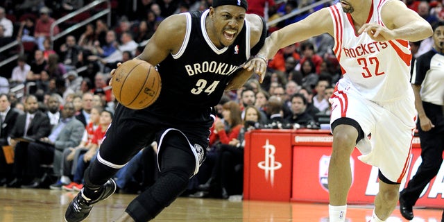 Brooklyn Nets' Paul Pierce (34) drives the ball past Houston Rockets' Francisco Garcia (32) in the first half of an NBA basketball game on Friday, Nov. 29, 2013, in Houston. (AP Photo/Pat Sullivan)