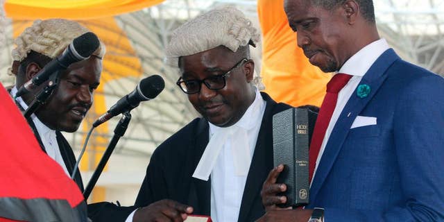 Jan. 25, 2015: Newly-elected Zambian president, Edgar Lungu, right, is sworn into office during an inauguration ceremony in Lusaka. (AP)
