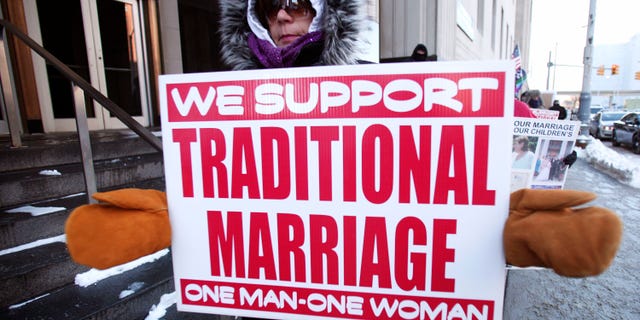 DETROIT, MI - MARCH 3: An advocate of traditional marriage protests in front of the U.S. Federal Courthouse March 3, 2014 in Detroit, Michigan. Plaintiffs Jayne Rowse and April DeBoer, a gay couple, have filed suit in Federal Court in an attempt to have Michigan's ban on gay marriage and gay adoption overturned. Current Michigan law defines marriage as the union between one man and one woman. (Photo by Bill Pugliano/Getty Images)