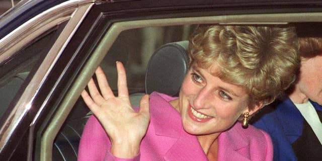 Diana, Princess of Wales waves to the crowd as she arrives at the Cite de la Musique at La Villette in Paris on November 14, 1992