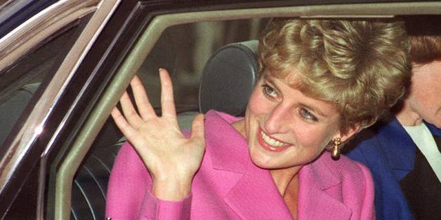 Diana, Princess of Wales waves to the crowd as she arrives at the Cite de la Musique at La Villette in Paris on November 14, 1992