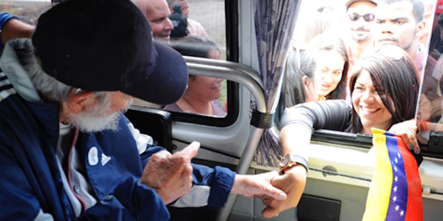 A screenshot of Cuba's website Cubadebate shows Fidel Castro on their opening page in Havana, Cuba, Saturday April 4, 2015. Former longtime Cuban president Fidel Castro has appeared in public for the first time in more than a year. The official website Cubadebate says Castro showed up to greet a group of Venezuelans visiting the capital of Havana last Monday. Cubadebate published four images on Frday April 3, 2015 that show Castro sitting inside a vehicle, each with a different person stretching an arm through the window to shake his hand. Castros face is largely obscured by a dark-colored baseball cap.(AP Photo)