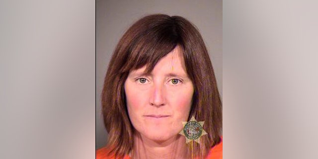This undated photo provided by the Multnomah County Sheriff's Office in Portland, Ore., shows Rebecca Rubin, 39, of Canada, who turned herself in to face federal charges alleging she was part of a radical environmental group based in Eugene, Ore., known as The Family. Federal authorities blame the group for 20 fires across the West between 1996 and 2001 that did $40 million in damage. Rubin was to be arraigned Friday, Sept. 11, 2013 in U.S. District Court in Eugene, Ore., on conspiracy and arson indictments. (AP Photo/Multnomah County Sheriff's Office)