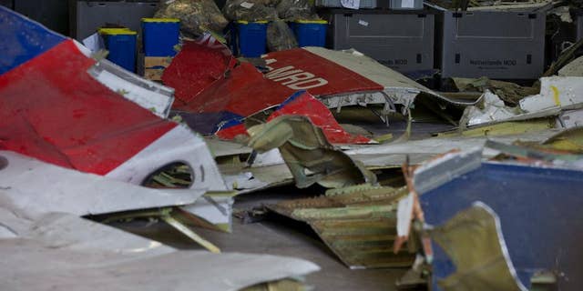 Parts of the wreckage of the Malaysia Airlines Flight 17 are displayed in a hangar at Gilze-Rijen airbase, Netherlands.