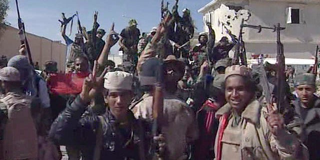 Oct. 20, 2011: Libyan fighters celebrate in the streets of Sirte, Libya, in this image taken from TV. The Libyan fighters on Thursday overran the remaining positions of Muammar Qaddafi loyalists in his hometown of Sirte, ending the last major resistance by former regime supporters still holding out two months after the fall of the capital Tripoli.