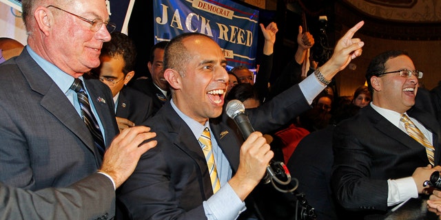 Democrat Jorge Elorza, center, celebrates his win over Independent Vincent Cianci, Jr. in the Providence mayoral race, Tuesday, Nov. 4, 2014, in Providence, R.I.. (AP Photo/Stew Milne)