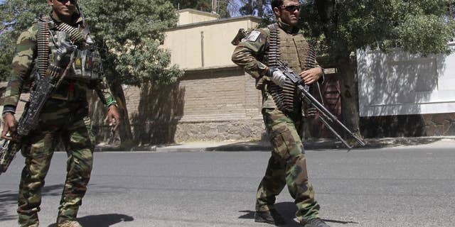 Afghanistan's National Army soldiers patrol in Herat, west of Kabul, Afghanistan, Wednesday, Aug. 12, 2015. The Taliban issued a statement about the fighting giving a much higher figure for police casualties. The insurgents regularly exaggerate their gains. (AP Photo/Hoshan Hashimi)