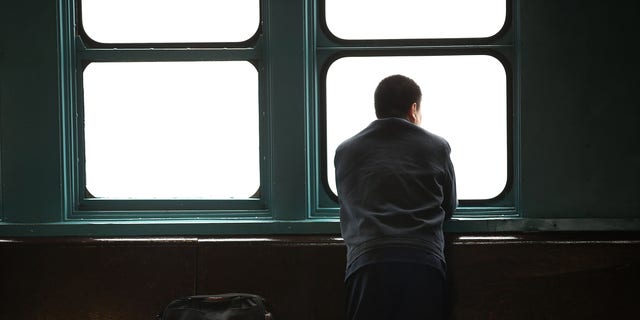 NEW YORK, NY - APRIL 30: A man looks out at lower Manhattan from the Staten Island Ferry during an afternoon of heavy rain and fog on April 30, 2014 in New York City. As the weather system that delivered deadly tornadoes to the South and Midwest earlier this week moves through the New York city area, high winds and heavy rains were experienced in much of the area.  (Photo by Spencer Platt/Getty Images)