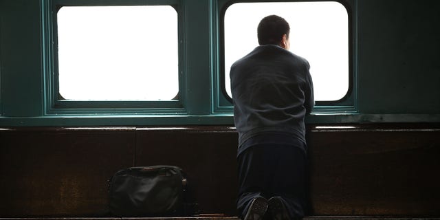 NEW YORK, NY - APRIL 30: A man looks out at lower Manhattan from the Staten Island Ferry during an afternoon of heavy rain and fog on April 30, 2014 in New York City. As the weather system that delivered deadly tornadoes to the South and Midwest earlier this week moves through the New York city area, high winds and heavy rains were experienced in much of the area. (Photo by Spencer Platt/Getty Images)