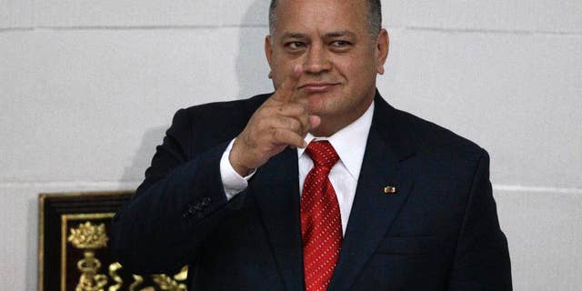 FILE - In this Jan. 5, 2013, file photo, National Assembly President Diosdado Cabello gestures before addressing the National Assembly in Caracas, Venezuela. Cabello said Tuesday, April 22, 2015, that he will file a lawsuit against the outlets that published reports in January saying his bodyguard had defected to the United States to testify that his former boss heads a drug ring of political and military officials. (AP Photo/Ariana Cubillos, File)