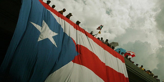 (October 15th, 2009) Thousands of protestors flooded the streets in the largest public gathering in Puerto Rican history.  The massive strike was in response to the republican governor Luis Fortuâo's decision to lay off 16,720 public workers.  ~ San Juan, Puerto Rico ~ Photo Â© 2009 Ricardo Figueroa
