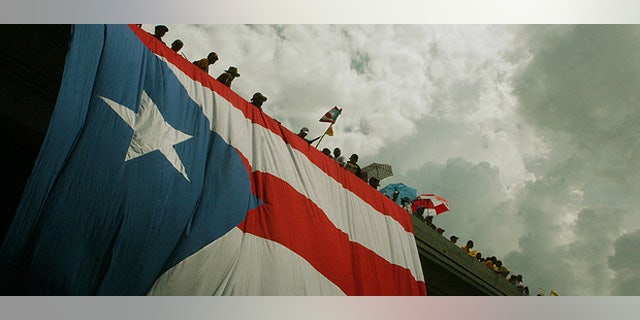 (October 15th, 2009) Thousands of protestors flooded the streets in the largest public gathering in Puerto Rican history. The massive strike was in response to the republican governor Luis Fortuâo's decision to lay off 16,720 public workers. ~ San Juan, Puerto Rico ~ Photo © 2009 Ricardo Figueroa