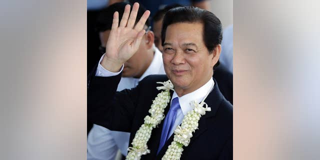 Vietnamese Prime Minister Nguyen Tan Dung waves to media shortly upon arrival at the Manila International Airport in Manila, Philippines Wednesday, May 21, 2014. Prime Minister Dung is here for the World Economic Forum in East Asia and for talks with Philippine President Benigno Aquino III that will focus on toughening cooperation as their countries wrangle with China in tense territorial standoffs in the South China Sea. (AP Photo/Bullit Marquez)