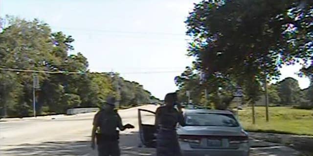 FILE - In this July 10, 2015, file frame from dashcam video provided by the Texas Department of Public Safety, trooper Brian Encinia arrests Sandra Bland after she became combative during a routine traffic stop in Waller County, Texas. Bland's family filed a wrongful-death lawsuit Tuesday, Aug. 4, 2015, against Encinia and other officials, saying it was a last resort after being unable to get enough information about the case. (Texas Department of Public Safety via AP, File)