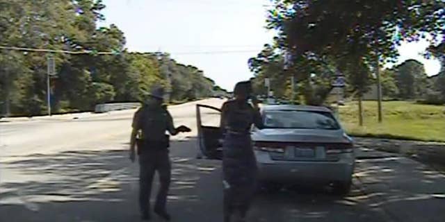 FILE - In this July 10, 2015, file frame from dashcam video provided by the Texas Department of Public Safety, trooper Brian Encinia arrests Sandra Bland after she became combative during a routine traffic stop in Waller County, Texas. Bland's family filed a wrongful-death lawsuit Tuesday, Aug. 4, 2015, against Encinia and other officials, saying it was a last resort after being unable to get enough information about the case. (Texas Department of Public Safety via AP, File)
