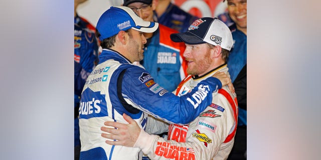 Dale Earnhardt Jr., right, celebrates in Victory Lane with teammate Jimmie Johnson, left, after winning the NASCAR Daytona 500 Sprint Cup series auto race at Daytona International Speedway in Daytona Beach, Fla., Sunday, Feb. 23, 2014. (AP Photo/Terry Renna)