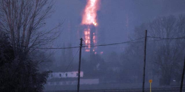 Flames and smoke billow following a blast in a refinery in Sannazzaro de Burgondi, near Pavia, northern Italy, Thursday, Dec. 1, 2016. Italian oil company Eni says a fire erupted in a refinery in Pavia province south of Milan, and that the flames were being extinguished. There were no immediate reports of injuries. (Dino Ferretti/ANSA via AP)