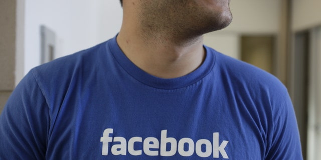 Feb. 8, 2012: A Facebook worker smiling inside Facebook headquarters in Menlo Park, Calif.
