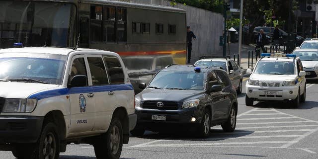 Three of the eight Turkish military officers are transferred in a police convoy to a court in Athens, Tuesday, April 25, 2017. Turkish servicemen who fled to Greece after last year's coup go back to court after Turkey submitted new evidence and re-issued their request for the servicemen's extradition. (AP Photo/Thanassis Stavrakis)