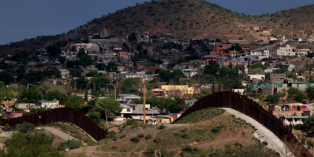 The U.S.- Mexico border wall in Nogales, Arizona. (Photo by Sandy Huffaker/Getty Images)
