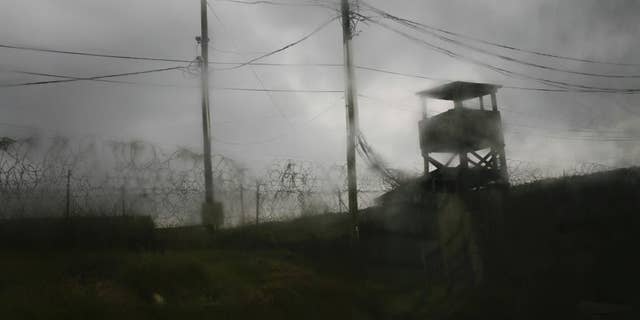 FILE - This May 14, 2008 file photo shows a guard tower in the abandoned Camp X-Ray, the original and temporary detention facility on Guantanamo Bay U.S. Naval Base in Cuba. The U.S. detention center at Guantanamo Bay, Cuba, appears to be at another turning point. President Donald Trump’s administration is expressing an interest in not just keeping it open but in resuming the broader detention and interrogation policies that made the detention center a focus of global protest over human rights. (AP Photo/Rodrigo Abd, File)