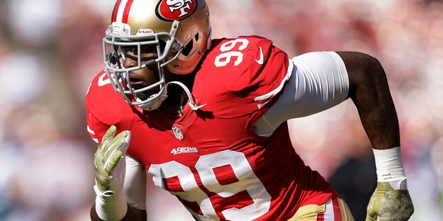 In this Nov. 10, 2013, file photo, San Francisco 49ers linebacker Aldon Smith warms up for the 49ers' NFL football game against the Carolina Panthers in San Francisco. Smith has been arrested at Los Angeles International Airport after authorities said he became belligerent during a security screening and threatened that he had a bomb.