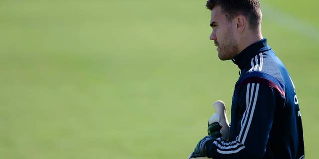Goalkeeper Igor Akinfeev looks at a ball during Russian national soccer team training session in Itu, Brazil, on Thursday, June 19, 2014. Russia will play next game against Belgium in group H of the 2014 soccer World Cup. (AP Photo/Ivan Sekretarev)