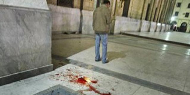 Feb. 22: Blood is seen on the ground following a bomb blast outside the Al-Husseini mosque.