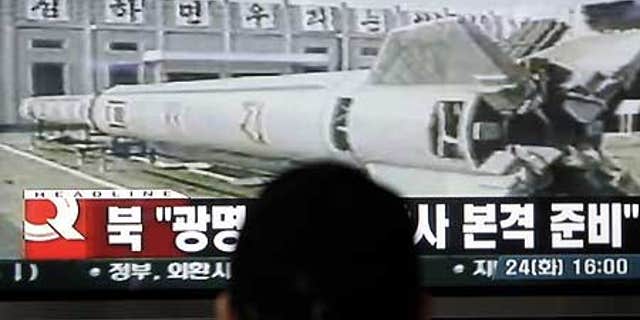Feb. 24: A South Korean watches television news showing a file image of North Korea's missile, at a railway station in Seoul.