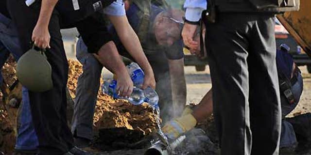 Feb. 3: Israeli police examine the remains of a rocket fired by Palestinian militants from the Gaza Strip, in the southern Israeli city of Ashkelon.