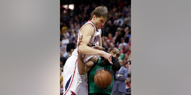 Atlanta Hawks guard Kyle Korver (26), left, works against Boston Celtics guard Rajon Rondo for the ball in the second of an NBA basketball game Friday, Jan. 25, 2013, in Atlanta. Atlanta won 123-111 in double-overtime. (AP Photo/John Bazemore)