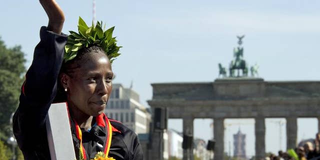 Florence Kiplagat of Kenya celebrates after the 38th Berlin Marathon on September 25, 2011