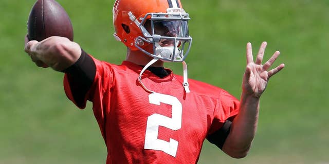 Cleveland Browns quarterback Johnny Manziel passes during practice at the NFL football team's facility in Berea, Ohio Wednesday, Sept. 3, 2014. Manziel begins the 2014 season on the bench behind starter Brian Hoyer. (AP Photo/Mark Duncan)