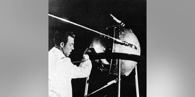 A Soviet technician works on Sputnik 1 before the satellite's Oct. 4, 1957, launch.