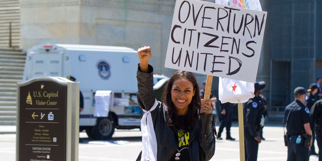 Actress Rosario Dawson takes part in a demonstration on Capitol Hill in Washington, Friday, April 15, 2016. The demonstration, called Democracy Spring, is advocating a set of reforms the organizers have dubbed the "democracy movement," demanding Congress amend campaign finance laws and restore the Voting Rights Act, among other actions. (AP Photo/Pablo Martinez Monsivais)