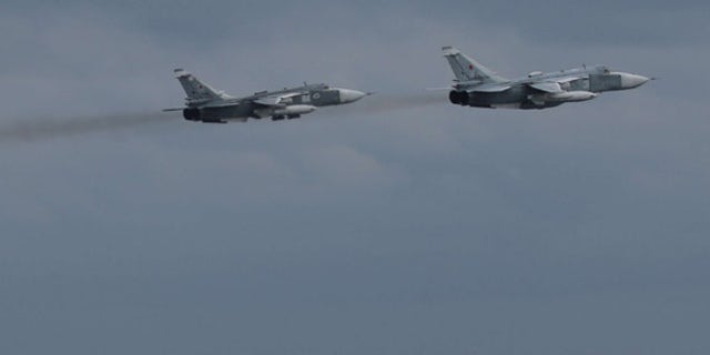 A pair of Russian Su-24 jets pass within close proximity of the guided-missile destroyer USS Porter in an aggressive action taken by Russia on Friday.
